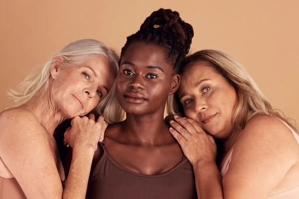 Image Three older woman together hugging.