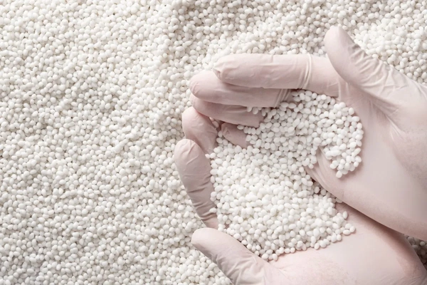 A person holding white granules