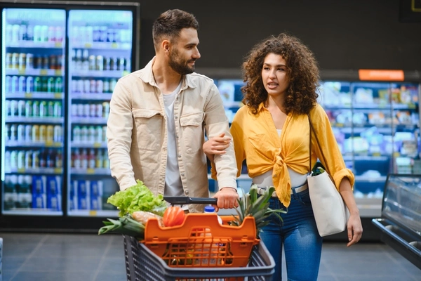 Couple shopping for fruit and vegetables, alternative proteins.