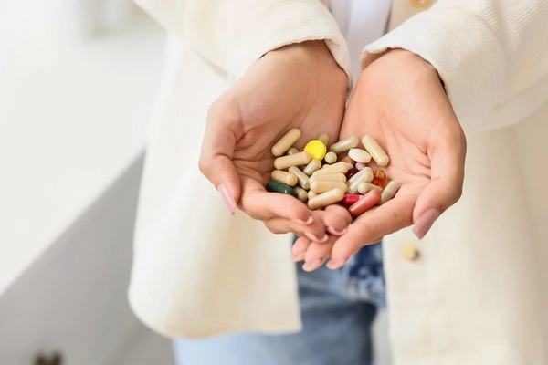Woman taking supplements Woman taking supplements