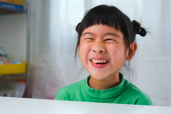 Image smiling little girl chewing something