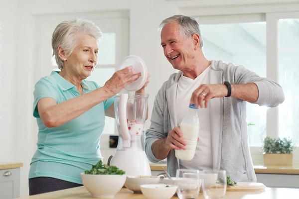 Elderly man and woman drinking protein shakes Elderly man and woman drinking protein shakes