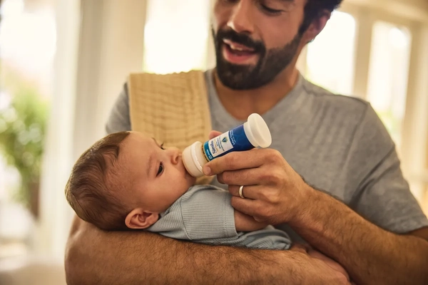 Image Father feeding his baby with Similac ready-to-feed formula