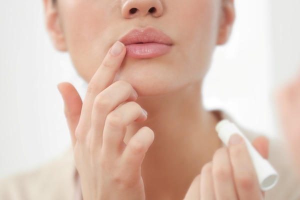 Person applying lip care.