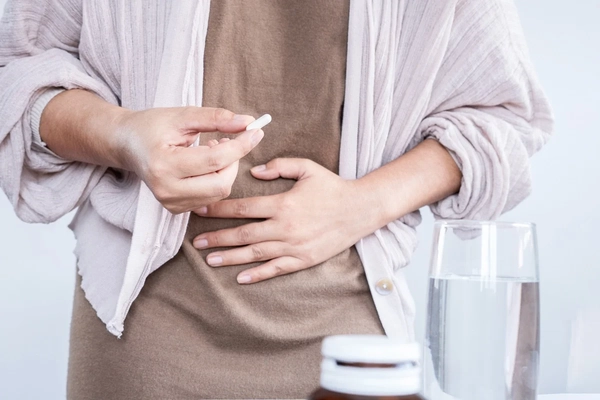 Woman taking gut health supplements Woman taking gut health supplements