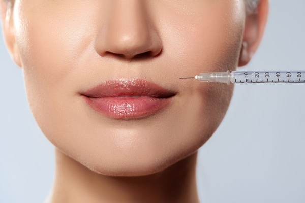 Image woman getting injection on mouth