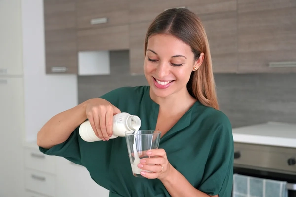 Image Woman pouring a probiotic drink