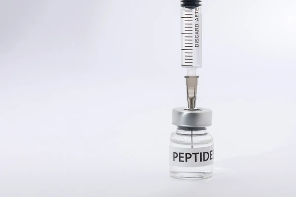 Image Medical peptide therapy syringe inside bottle