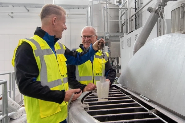 Image two men in a factory