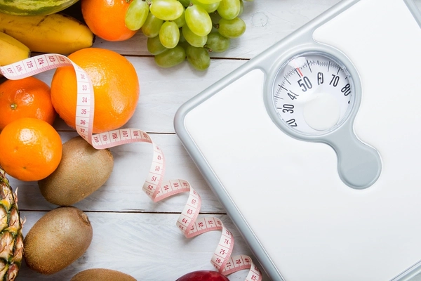 Weighing scale next to fresh fruits