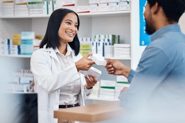 Image happy pharmacist helps customer with pills choice, supplements decision