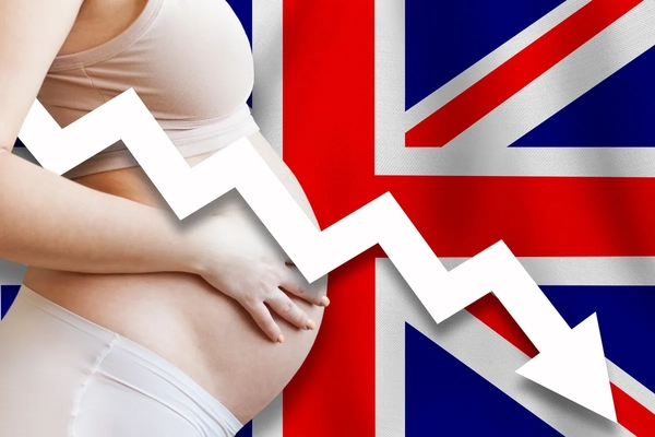 pregnant woman in front of UK flag