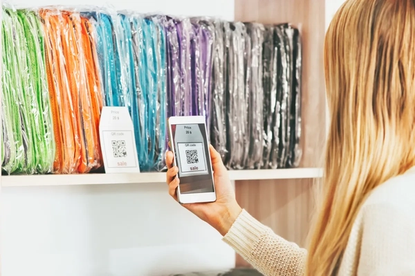 Image A woman scanning a QR code