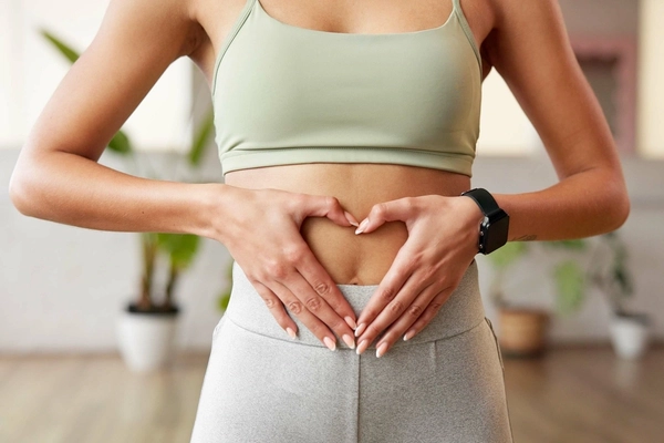 Woman holding her stomach Woman holding her stomach