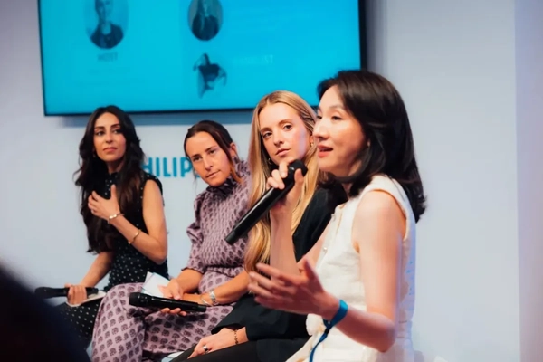 Women speaking at a conference.
