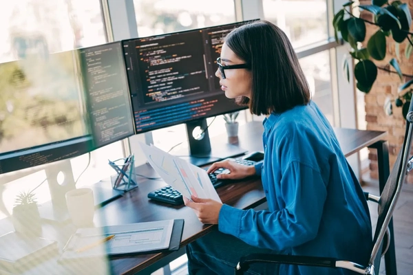 A woman working with computers